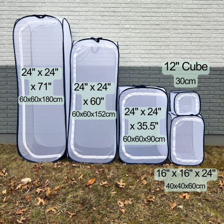 Five different sizes of pop up cages are lined up against a gray wall from largest (on the left) to smallest (on the right). The largest size is 24 inches by 24 inches by 71 inches and the smallest size is a 12 inch cube. The cages have a white mesh, navy blue boarder, and white zipper.